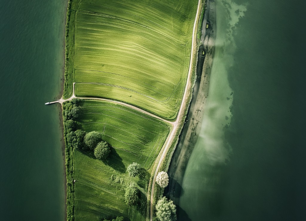 Aerial view of sustainably managed green farmland by the coast